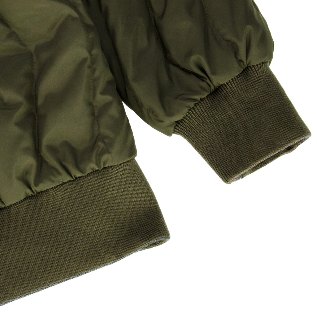 close up green padded jackets flat lying